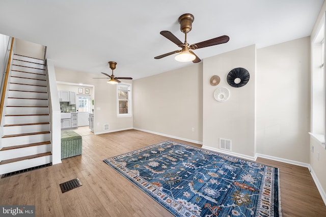 interior space with ceiling fan and wood-type flooring