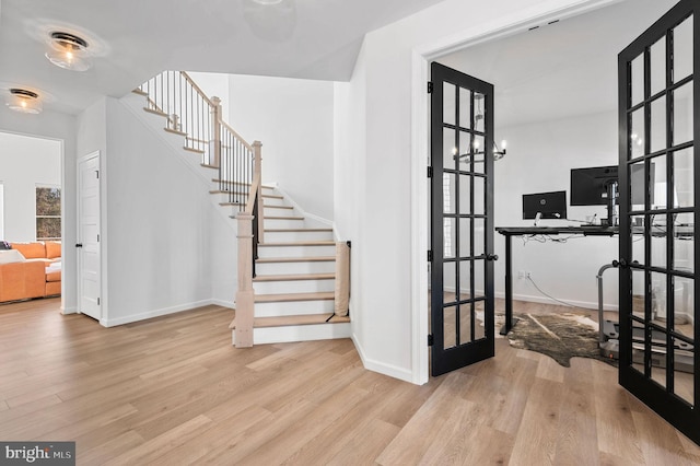 stairway featuring french doors and hardwood / wood-style flooring