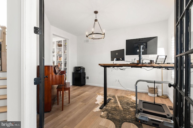 office area with a notable chandelier and light wood-type flooring