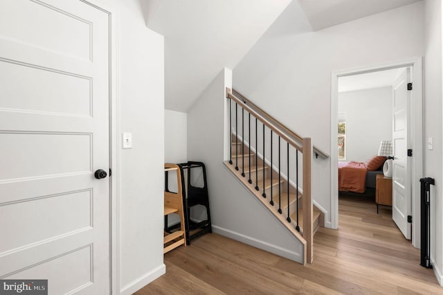 stairway with hardwood / wood-style flooring