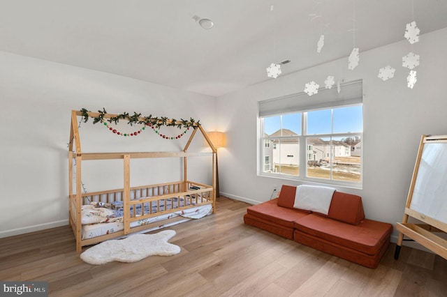 bedroom with hardwood / wood-style flooring