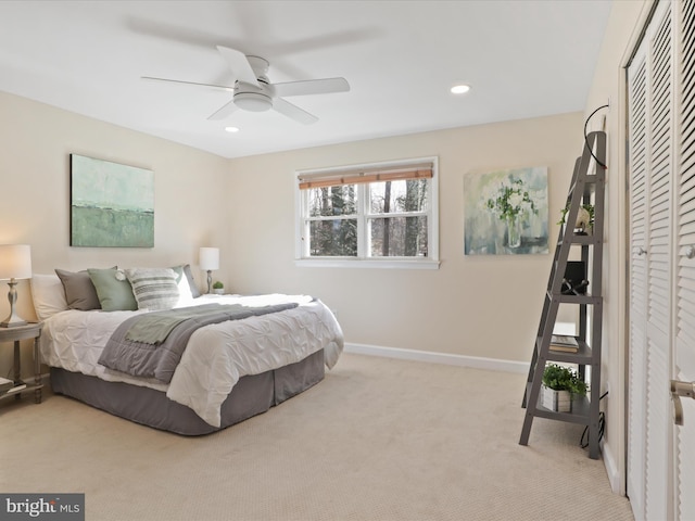 bedroom featuring ceiling fan, a closet, and light carpet