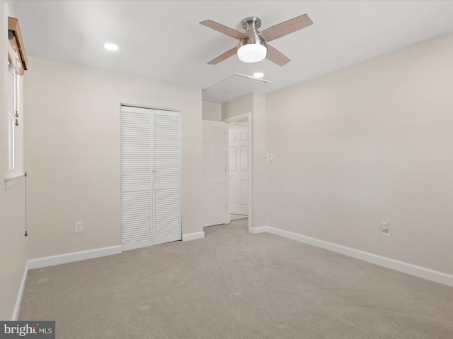 unfurnished bedroom with light carpet, a closet, and ceiling fan