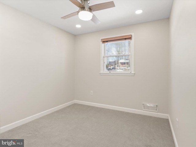 carpeted empty room featuring ceiling fan