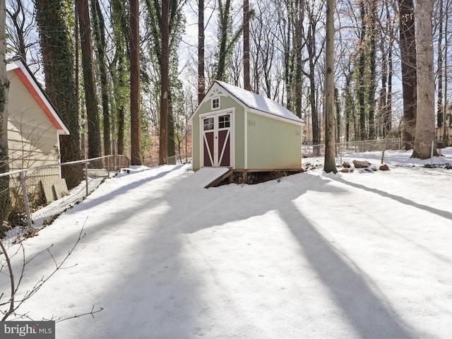 yard covered in snow with a storage unit