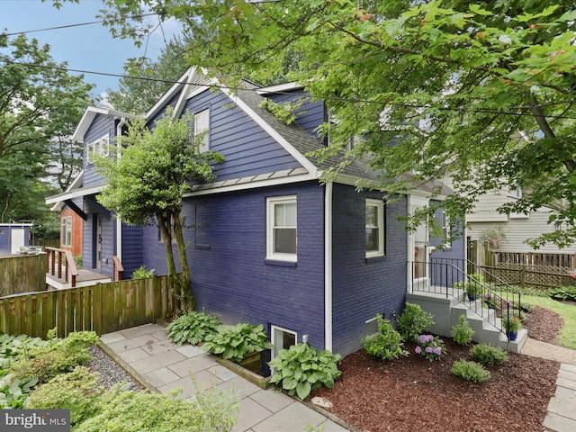 6230 21st St N, Arlington, VA 22205 - view of side of property featuring brick siding and a shingled roof