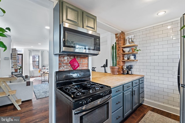 kitchen featuring butcher block countertops, stainless steel appliances, and dark wood-type flooring