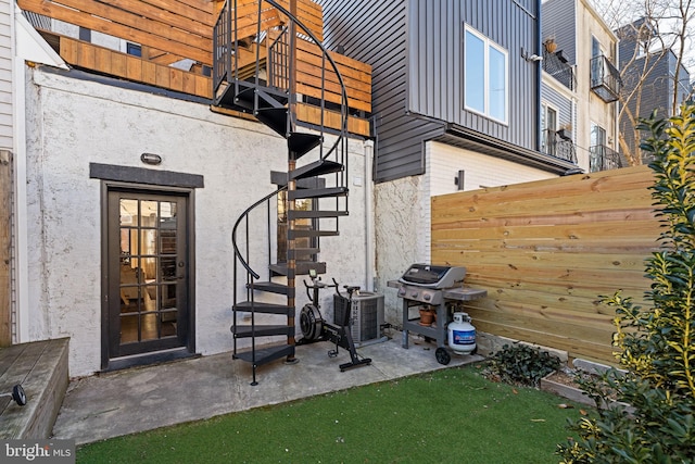 property entrance with central AC and a patio