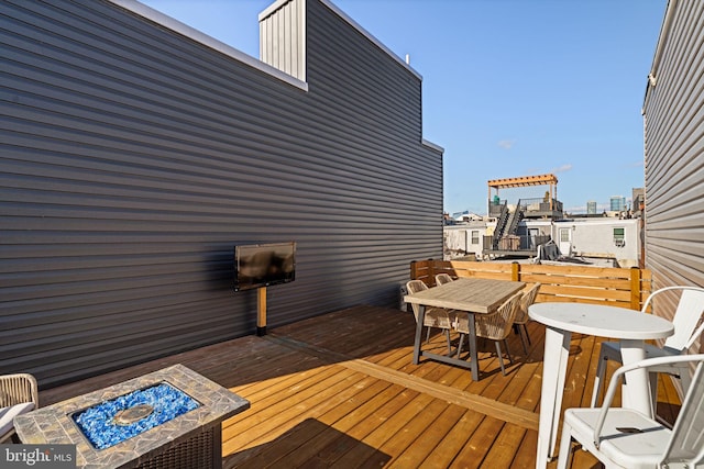 wooden terrace with an outdoor fire pit