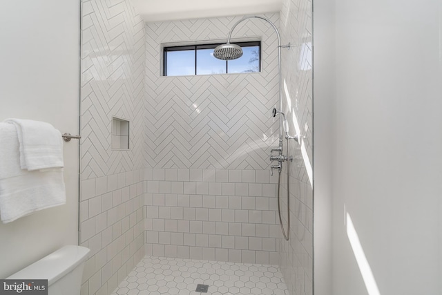 bathroom featuring a shower stall and toilet