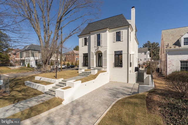 view of front of home with a residential view and a chimney