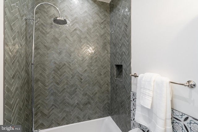 full bath with a tile shower