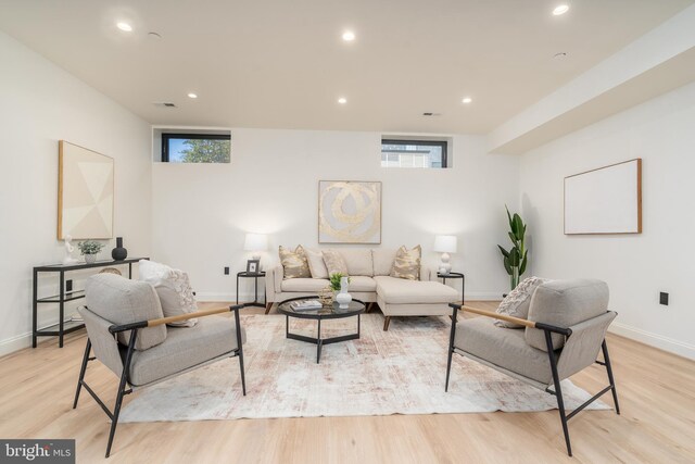 living area with recessed lighting, baseboards, and light wood finished floors