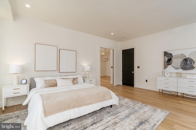 bedroom featuring recessed lighting, light wood-type flooring, and baseboards