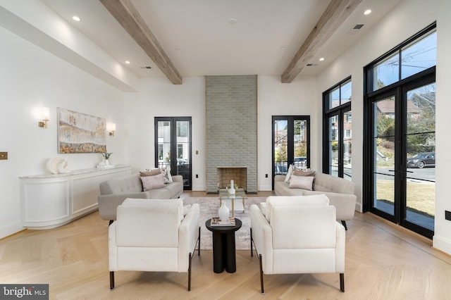 living room with visible vents, baseboards, french doors, a towering ceiling, and beamed ceiling