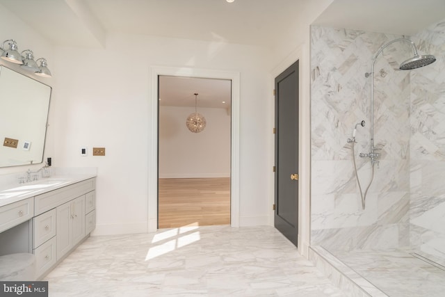 full bath featuring a marble finish shower, baseboards, marble finish floor, and vanity