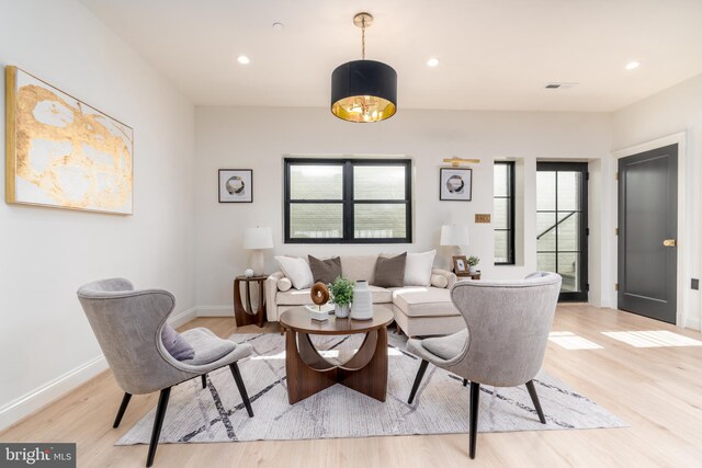 living area with recessed lighting, light wood-style floors, and a healthy amount of sunlight