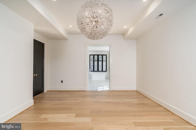 spare room featuring recessed lighting, baseboards, and light wood finished floors