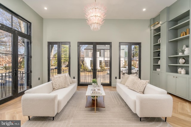 living area featuring an inviting chandelier, french doors, and a wealth of natural light