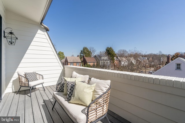 wooden terrace with a residential view and an outdoor hangout area