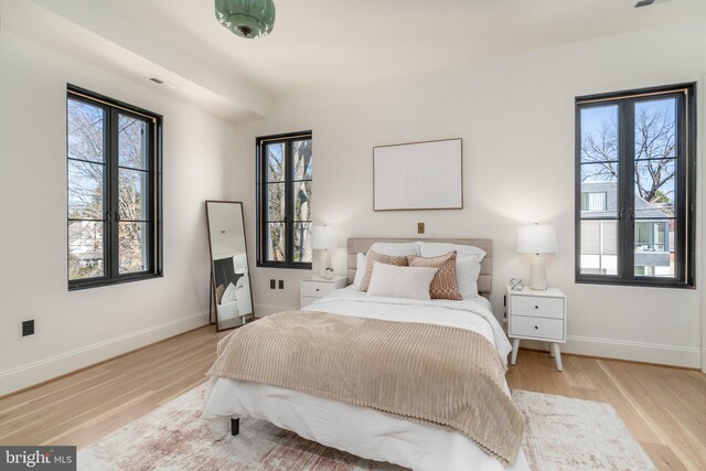 bedroom with baseboards and wood finished floors