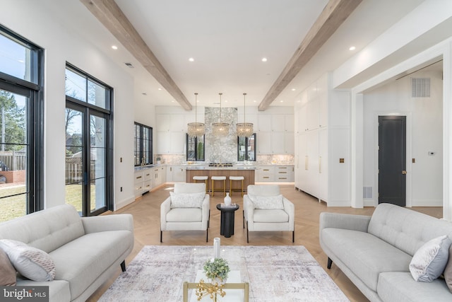 living area with beam ceiling, visible vents, recessed lighting, and baseboards