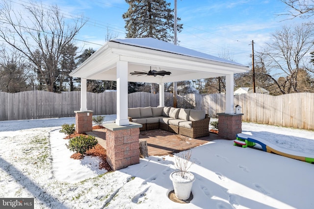 snow covered patio with ceiling fan and outdoor lounge area