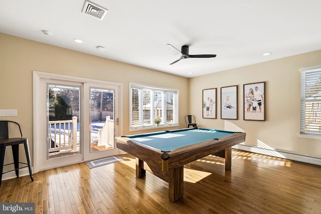 recreation room with hardwood / wood-style flooring, ceiling fan, a baseboard radiator, and billiards