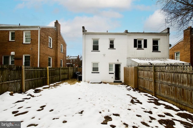 view of snow covered rear of property