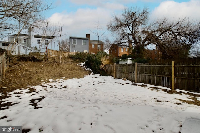 view of yard layered in snow