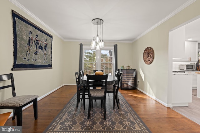 dining area with crown molding and wood-type flooring