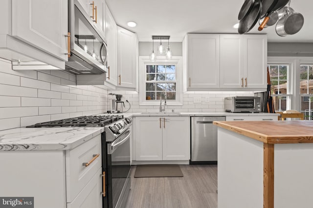 kitchen featuring white cabinetry, appliances with stainless steel finishes, and sink