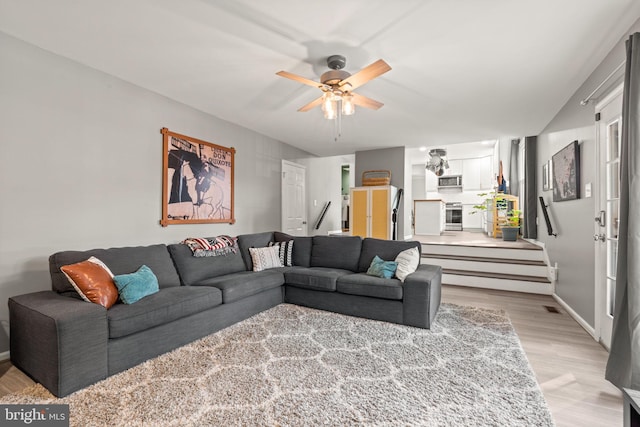 living room with ceiling fan and light wood-type flooring