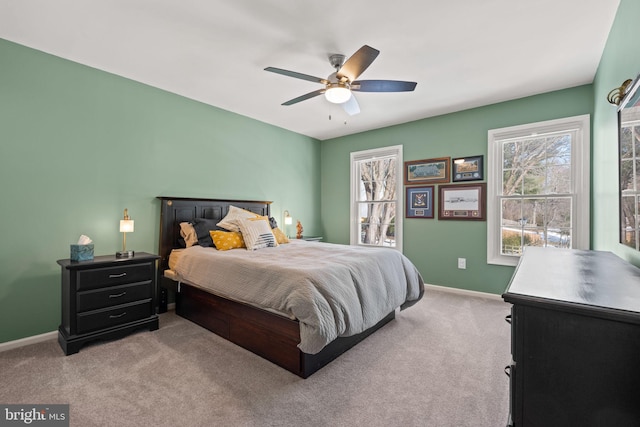 bedroom with ceiling fan and light carpet