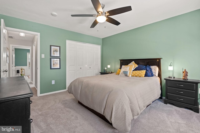 carpeted bedroom featuring a closet and ceiling fan