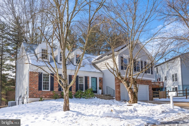 view of front of home featuring a garage and central AC unit