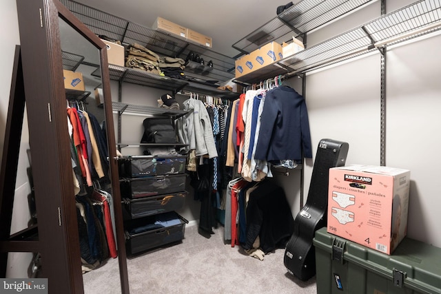 walk in closet featuring light carpet