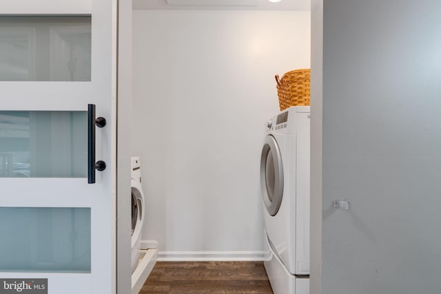 laundry room featuring washer / clothes dryer and dark wood-type flooring