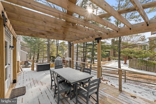 snow covered deck with a pergola