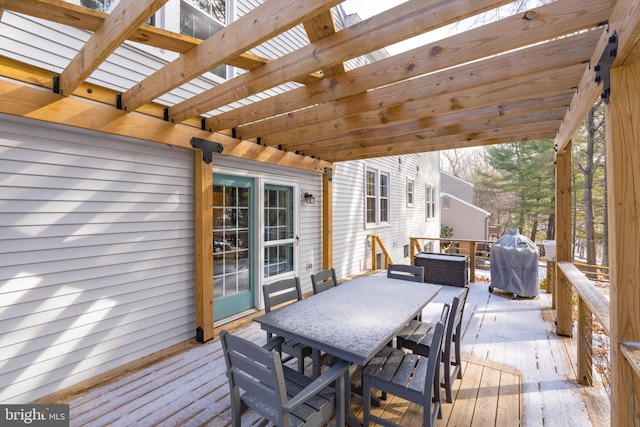 wooden deck featuring area for grilling and a pergola