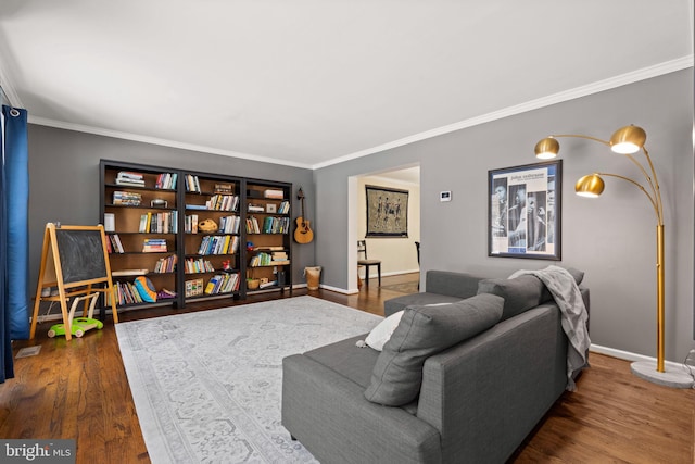 living room with dark hardwood / wood-style flooring and crown molding