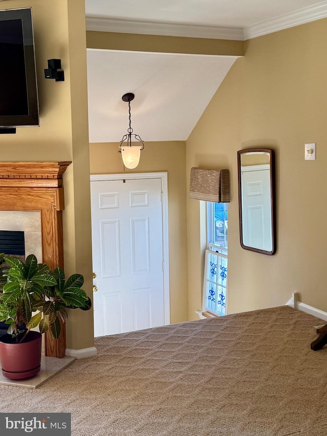 entryway with lofted ceiling, a premium fireplace, and ornamental molding