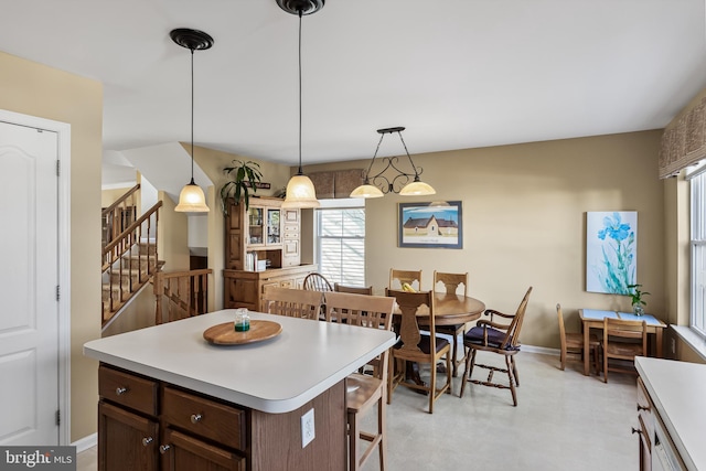 kitchen featuring a kitchen island, dark brown cabinets, and hanging light fixtures