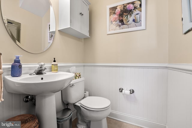 bathroom featuring toilet and tile patterned floors