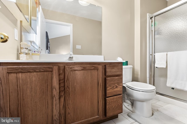 bathroom with toilet, a shower with door, vanity, and tile patterned floors