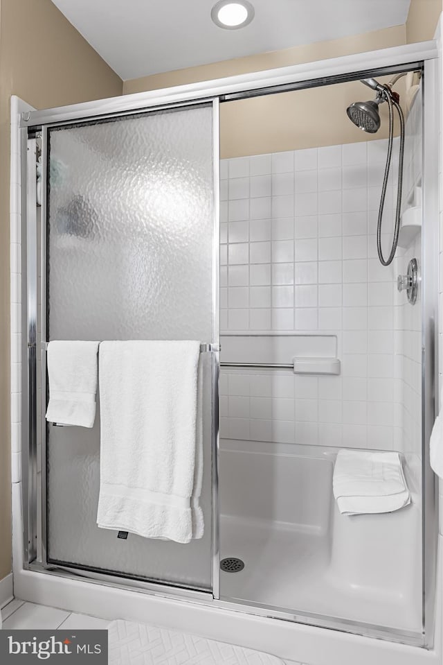 bathroom with tile patterned flooring and an enclosed shower