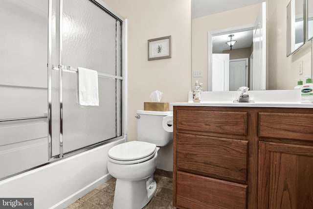 full bathroom with combined bath / shower with glass door, vanity, and toilet