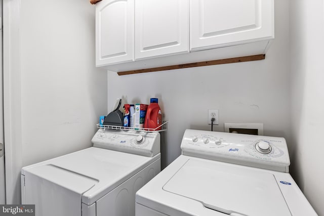 laundry area with cabinets and washing machine and dryer