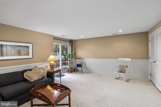 sitting room featuring light colored carpet