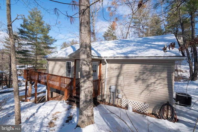 exterior space with central air condition unit and a deck